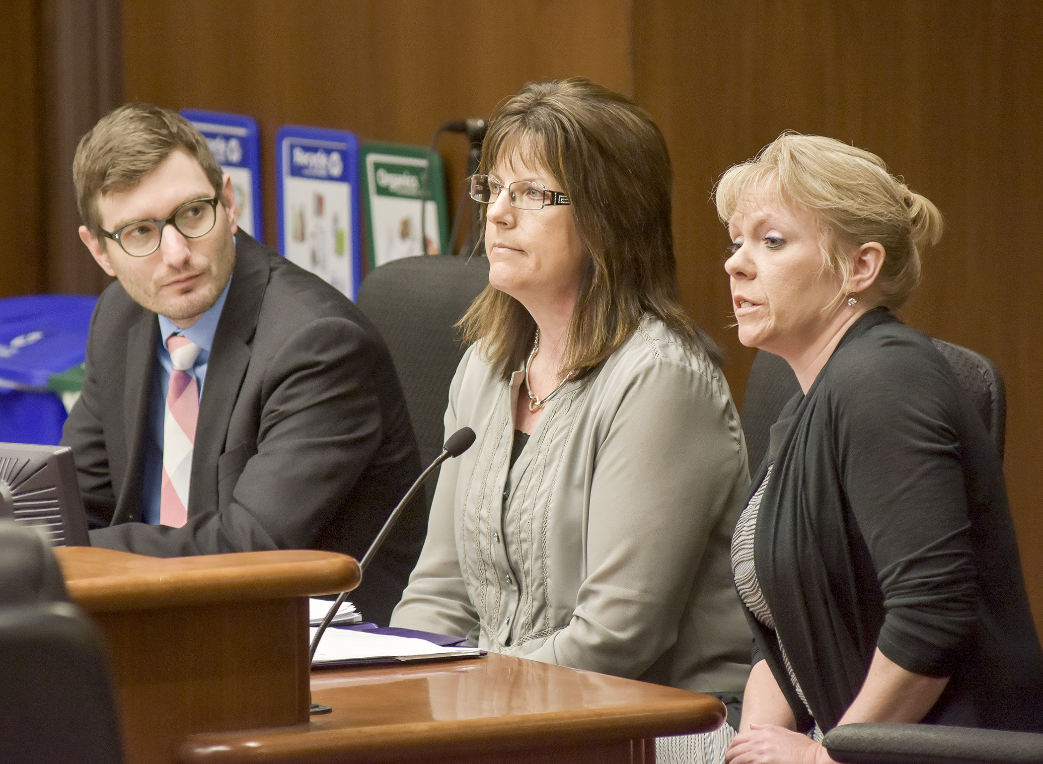 Cindy Brown testifies before the House Health and Human Services Reform Committee March 14 in support of a bill sponsored by Rep. Jason Metsa, left, that would provide a group residential housing supplemental rate for a provider in St. Louis County. Shelly Holmes, center, also spoke for the bill. Photo by Andrew VonBank